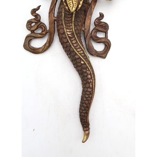 2452 - A BRASS NAAG KANYA WALL HANGING The snake Goddess holding a conch shell, 37cm high... 