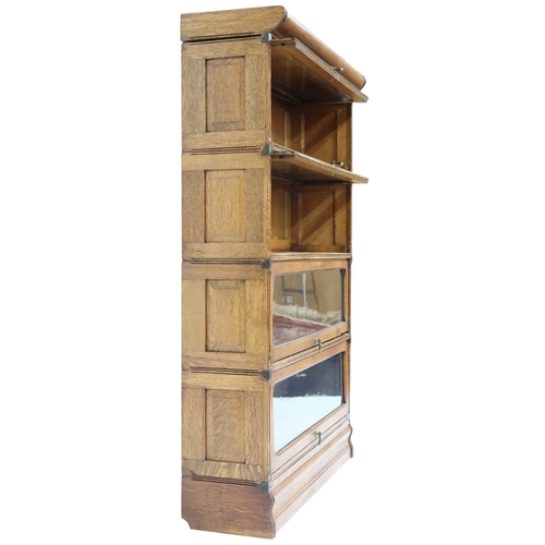 2026 - AN EARLY 20TH CENTURY OAK FOUR TIER SECTIONAL BOOKCASE with four glazed fall front slide back d... 