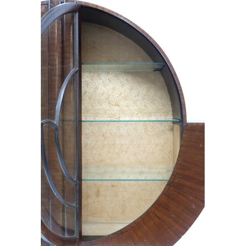 2028 - AN ART DECO  MAHOGANY VENEERED  CIRCULAR DISPLAY CABINET with pair of half crescent glazed doors on ... 