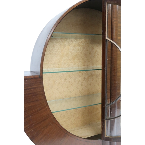 2028 - AN ART DECO  MAHOGANY VENEERED  CIRCULAR DISPLAY CABINET with pair of half crescent glazed doors on ... 