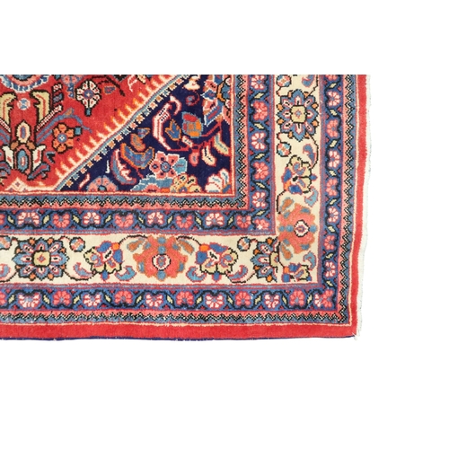 2151 - A RED GROUND MAHAL RUG with multicoloured floral pattern design ground with dark blue spandrels... 