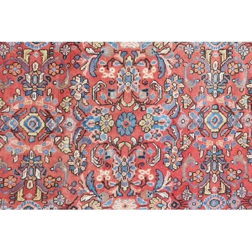 2151 - A RED GROUND MAHAL RUG with multicoloured floral pattern design ground with dark blue spandrels... 