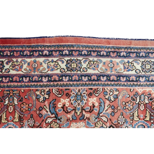 2151 - A RED GROUND MAHAL RUG with multicoloured floral pattern design ground with dark blue spandrels... 