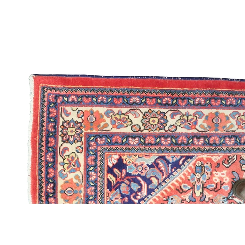 2151 - A RED GROUND MAHAL RUG with multicoloured floral pattern design ground with dark blue spandrels... 