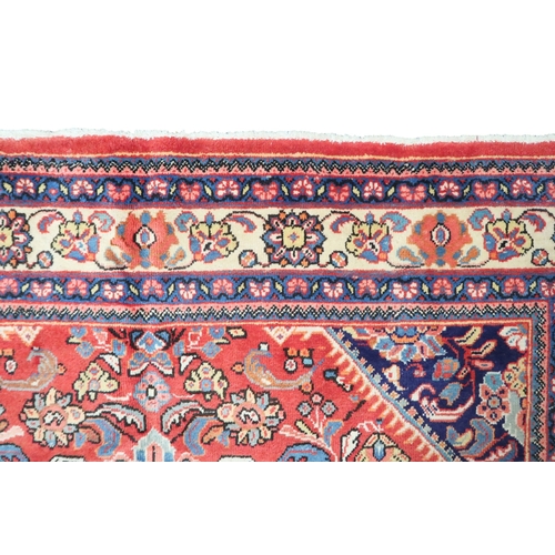 2151 - A RED GROUND MAHAL RUG with multicoloured floral pattern design ground with dark blue spandrels... 