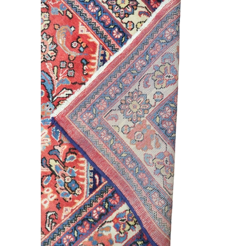 2151 - A RED GROUND MAHAL RUG with multicoloured floral pattern design ground with dark blue spandrels... 