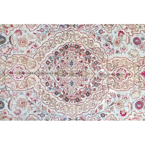 2152 - AN IVORY GROUND UNIQUE TABRIZ RUG with floral patterned central medallion and spandrels on flor... 