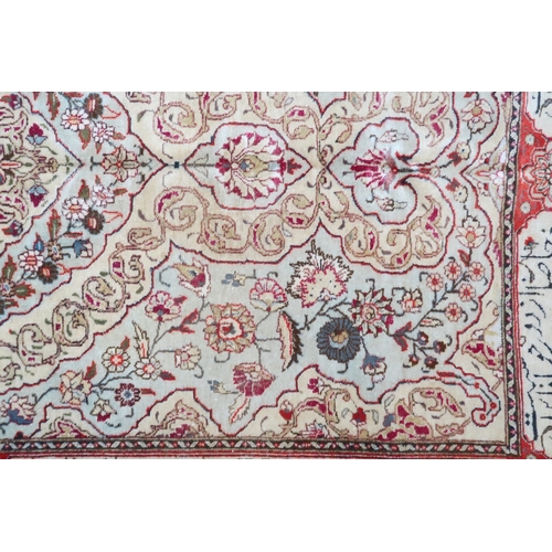 2152 - AN IVORY GROUND UNIQUE TABRIZ RUG with floral patterned central medallion and spandrels on flor... 