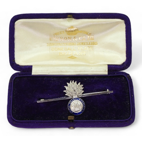 2617 - A ROYAL WELCH FUSILIERSbrooch in 18ct and 14ct white gold, the flames are set with rose cut diamonds... 