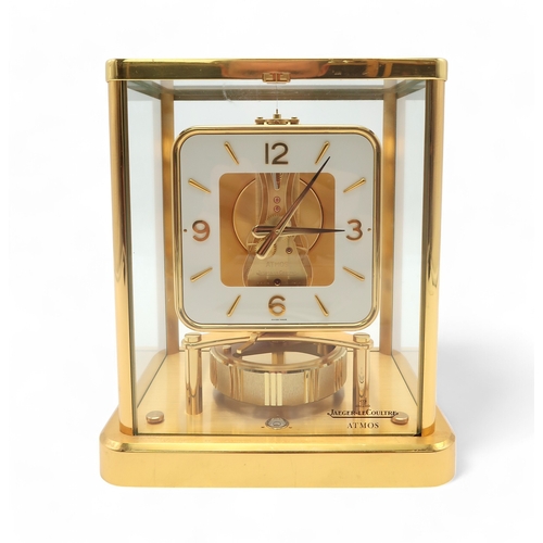 2258 - A JAEGER LE COULTRE GILT BRASS AND GLASS ATMOS CLOCKwith white square chapter ring dial, with arabic... 