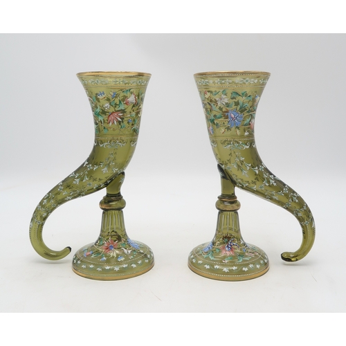 2262 - A PAIR OF MOSER GREEN GLASS CORNUCOPIA VASESeach painted with enamel decoration of flowers, scrollin... 