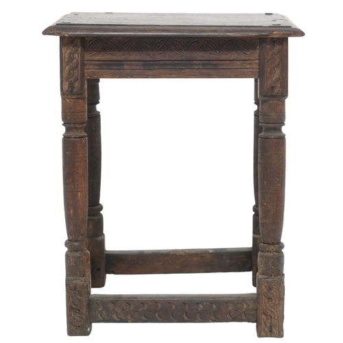 2035 - AN 18TH CENTURY OAK JOINTED STOOL with rectangular top on turned supports joined by carved frie... 