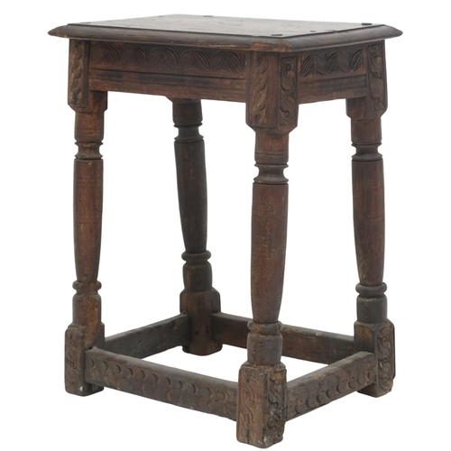 2035 - AN 18TH CENTURY OAK JOINTED STOOL with rectangular top on turned supports joined by carved frie... 