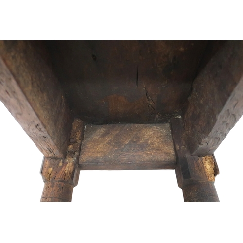 2035 - AN 18TH CENTURY OAK JOINTED STOOL with rectangular top on turned supports joined by carved frie... 