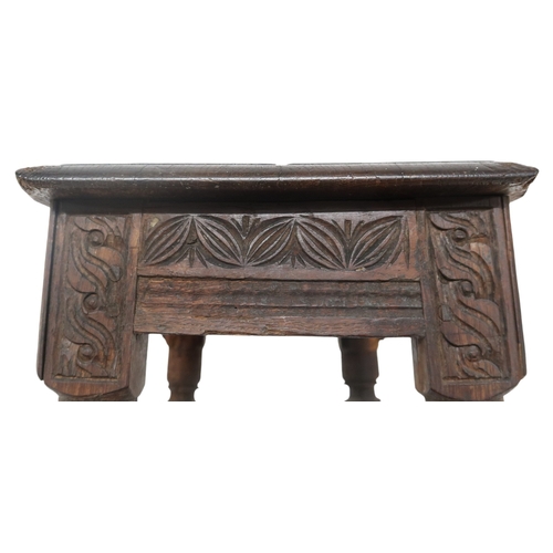 2035 - AN 18TH CENTURY OAK JOINTED STOOL with rectangular top on turned supports joined by carved frie... 