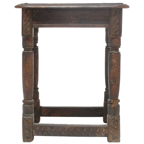 2035 - AN 18TH CENTURY OAK JOINTED STOOL with rectangular top on turned supports joined by carved frie... 