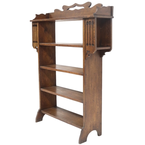 2043 - A LATE 19TH CENTURY OAK ARTS & CRAFTS OPEN BOOKCASE with pierced shaped gallery top over fo... 