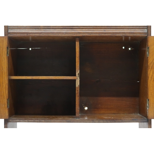 2044 - A LATE 19TH CENTURY ASH ARTS & CRAFTS SMOKERS CABINET with pair of panel doors with hammere... 