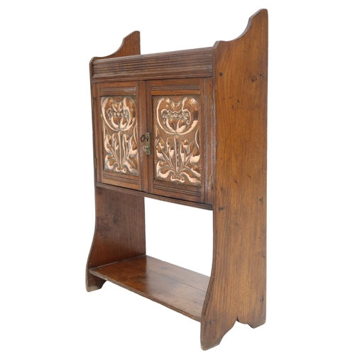 2044 - A LATE 19TH CENTURY ASH ARTS & CRAFTS SMOKERS CABINET with pair of panel doors with hammere... 