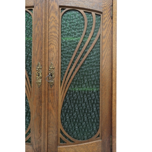 2045 - AN EARLY 20TH CENTURY OAK ARTS & CRAFTS STAINED GLASS CABINET with stylized pierced gallery... 