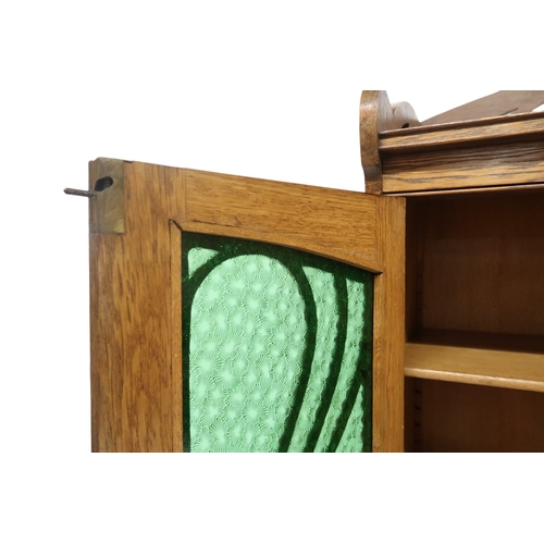 2045 - AN EARLY 20TH CENTURY OAK ARTS & CRAFTS STAINED GLASS CABINET with stylized pierced gallery... 