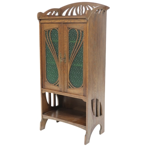 2045 - AN EARLY 20TH CENTURY OAK ARTS & CRAFTS STAINED GLASS CABINET with stylized pierced gallery... 