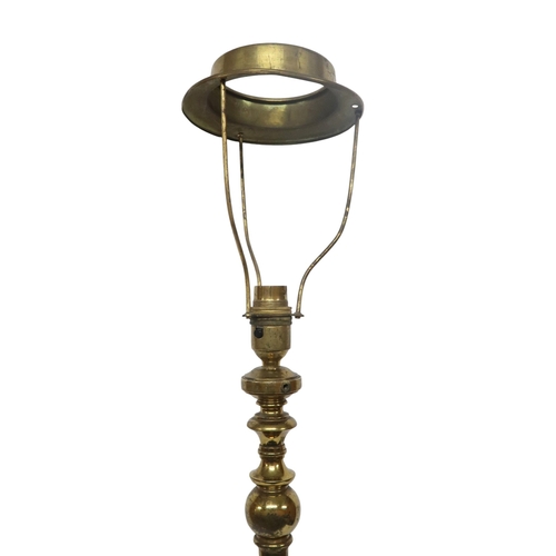 2054 - AN ARTS AND CRAFTS BRASS  TELESCOPIC STANDARD LAMP with tripod base decorated with scrolls and twist... 