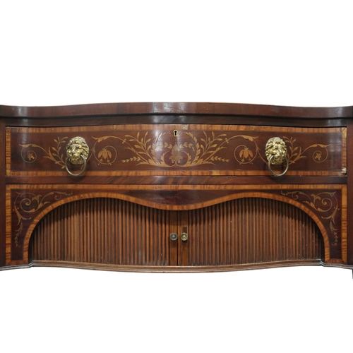 2055 - A GEORGIAN MAHOGANY AND CROSSBAND INLAID SERPENTINE FRONT SIDEBOARD with long central drawer over pa... 