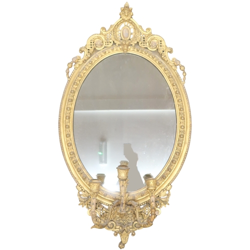 2056 - A 19TH CENTURY GILT ROCOCO OVAL GIRANDOLE WALL MIRROR with scrolling pierced surmount over oval... 