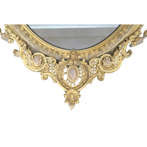 2056 - A 19TH CENTURY GILT ROCOCO OVAL GIRANDOLE WALL MIRROR with scrolling pierced surmount over oval... 