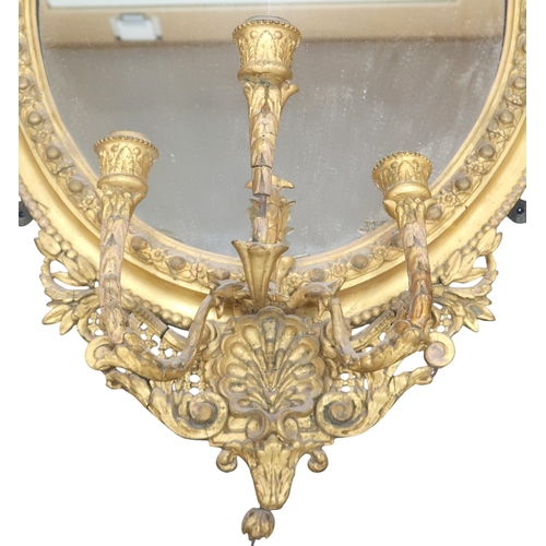 2056 - A 19TH CENTURY GILT ROCOCO OVAL GIRANDOLE WALL MIRROR with scrolling pierced surmount over oval... 