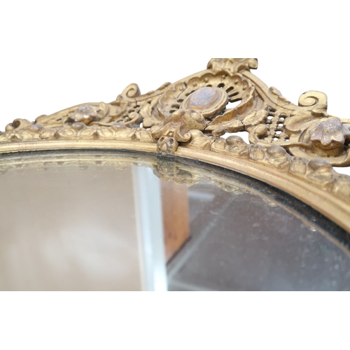 2056 - A 19TH CENTURY GILT ROCOCO OVAL GIRANDOLE WALL MIRROR with scrolling pierced surmount over oval... 