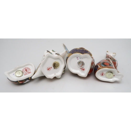 201 - Four Royal Crown Derby paperweights including Monkey and Baby, silver stopper, Dolphin, Cat and Catn... 