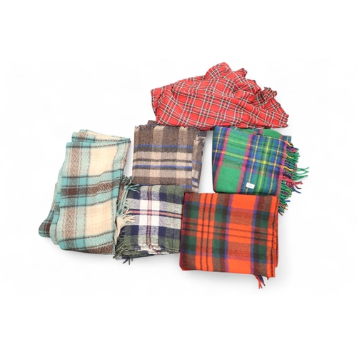 253 - Assorted tartan wool blankets and a length of plaid