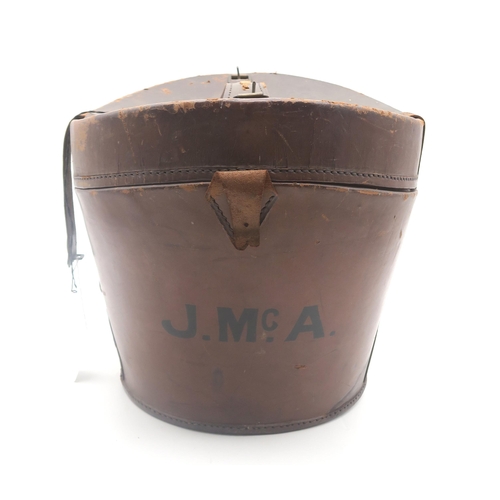 513 - A brown leather Gladstone bag, measuring approx. 46cm in length; together with a leather top hat cas... 