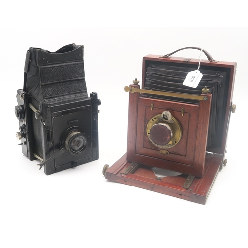 519 - A mahogany and brass bellows camera, fitted with a Bausch & Lomb 