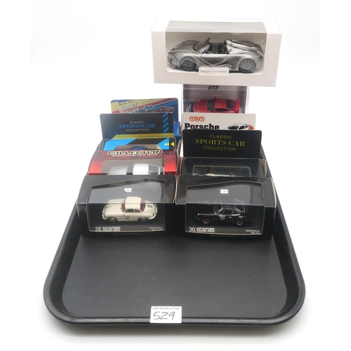 529 - A large collection of diecast model Porsche cars, to include 22 boxed Burago 1:43-scale examples, wi... 