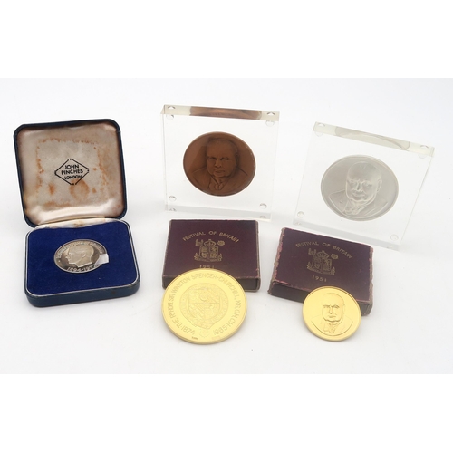 567 - A collection of commemorative coins and medallions, to include two hallmarked silver gilt Churchill ... 