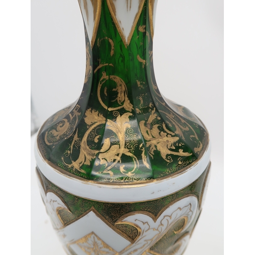 2263 - A PAIR OF BOHEMIAN WHITE OVERLAY GREEN GLASS VASESof typical urn shape, with painted gilt scrolling ... 