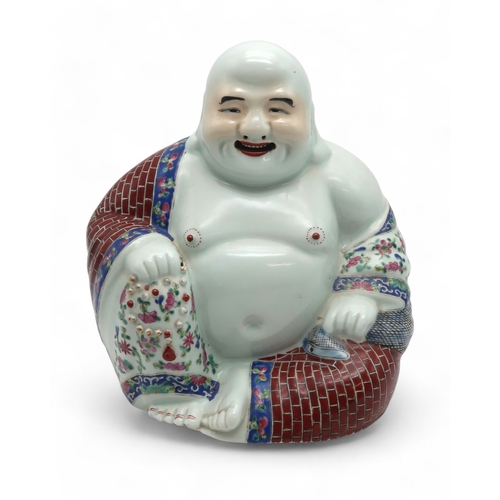 2460 - A CANTONESE MODEL OF BUDDHA Seated and holding prayer beads and wearing red brick patterned robe,25c... 