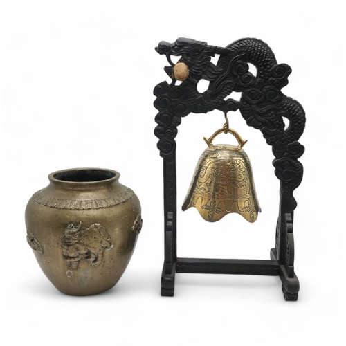 2462 - A CHINESE BRASS TABLE BELL Hung on a dragon shaped ebonised stand,50cm high and a brass vase cast wi... 