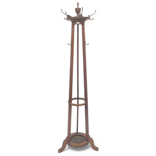 21 - An early 20th century mahogany hat and coat stand with finial top over revolving hooks over central ... 