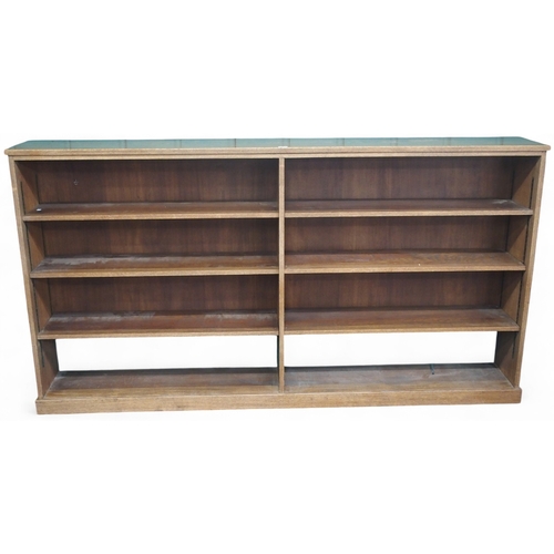 3 - A large early 20th century oak open bookcase with three pairs of open adjustable shelves on plinth b... 