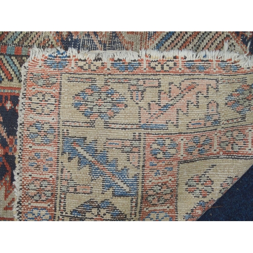 32 - A dark blue ground Hamadan rug with terracotta central medallion and cream spandrels on geometric pa... 