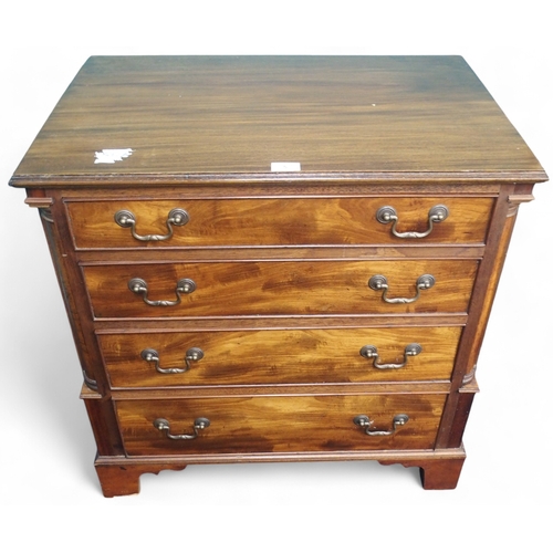 5 - A 20th century mahogany chest of drawers with four graduating drawers with brass drawer pulls on bra... 