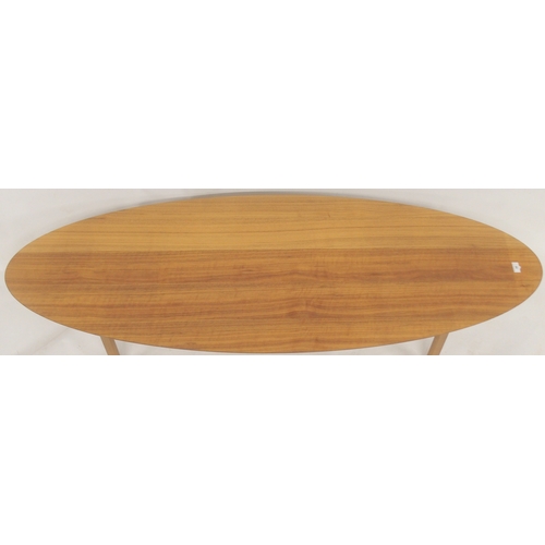 50 - A contemporary Ikea Stockholm surfboard style coffee table with walnut veneered top on splayed suppo... 