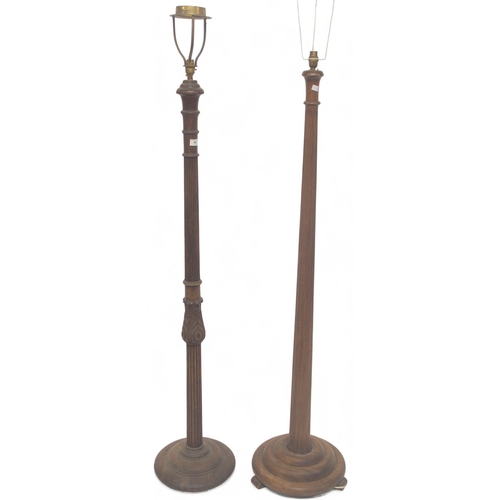 64 - A lot comprising tow assorted oak standard lamps with fluted column uprights on circular bases (2)