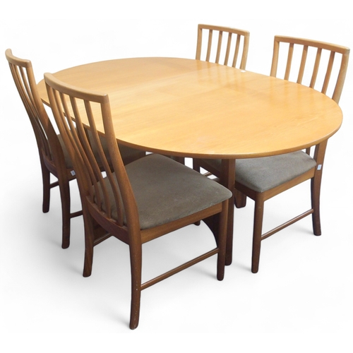 67 - A mid 20th century teak McIntosh dining table and four chairs, dining table with drop ends of shaped... 