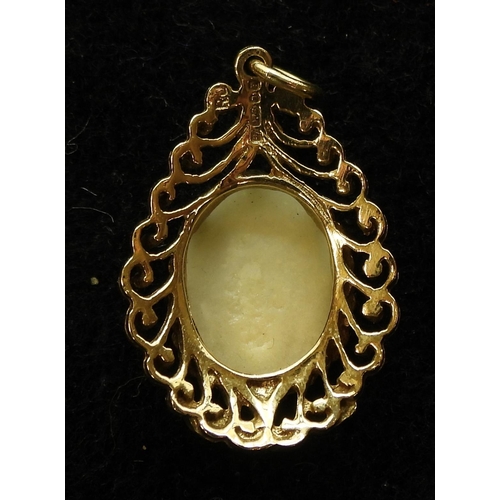 705 - A 9ct gold pendant, set with an approx 14mm x 10mm white opal, weight 3.1gms together with a 18ct go... 