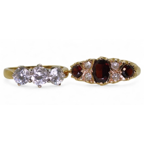 723 - A 9ct gold three clear gem set ring, size N1/2, and a three stone garnet ring, size N, weight togeth... 